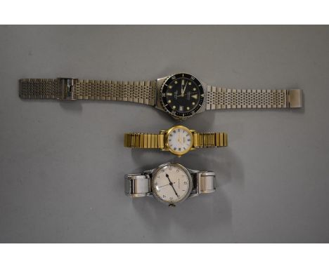 A 1940s Longines steel manual wind wristwatch, No. 6489023, 32mm, on Expandro stainless steel bracelet; together with two oth