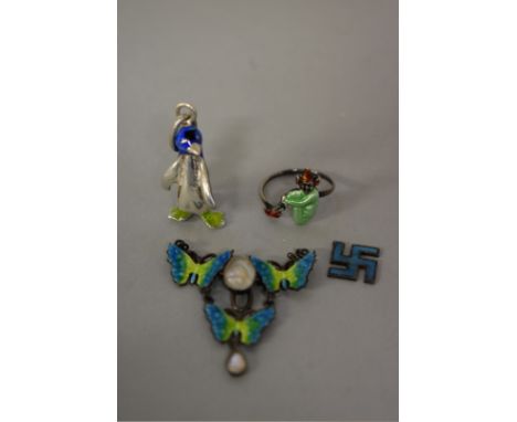 Four items of enamel jewellery, to include a butterfly pendant and a penguin pendant. 