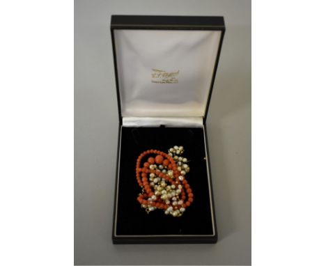 A freshwater pearl necklace, the clasp hallmarked 375; together with a graduated coral bead necklace, (both a.f). 