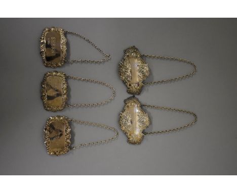 A pair of silver decanter labels, by Royal Irish Silver Co, Sheffield 1973; together with three other examples, 72g. (5) 