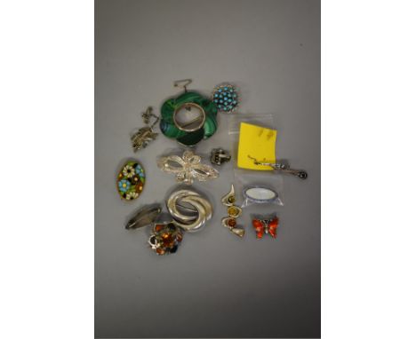 An oval silver and enamel brooch; together with two Celtic brooches; and various other jewellery items. (13) 