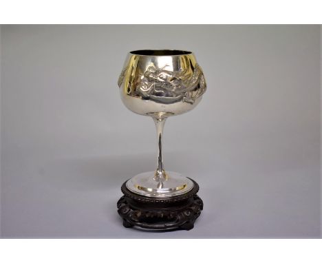 A Chinese silver goblet, by Wang Hing &amp; Co, repousse decorated with a dragon, 15.5cm high, 255g, on carved and pierced&nb