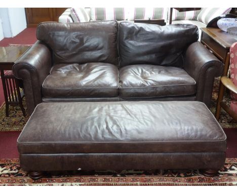 A Fishpools leather sofa together with matching foot stool 