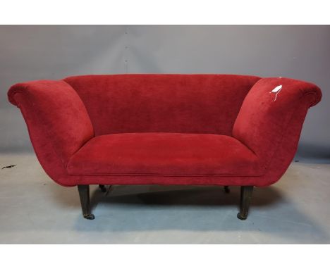 An early 19th century sofa recently upholstered in a red velour, raised on tapered mahogany legs and castors, H.80 W.148 D.59