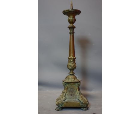 A 19th century copper pricket candlestick, with acanthus decoration raised on three lion paw feet, H.77cm 