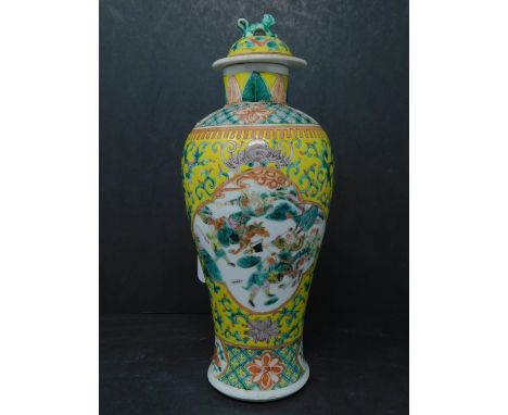A 19th century Chinese famille jaune vase, the lid having Dog of Fo finial, decorated with vignettes of warriors, on a yellow