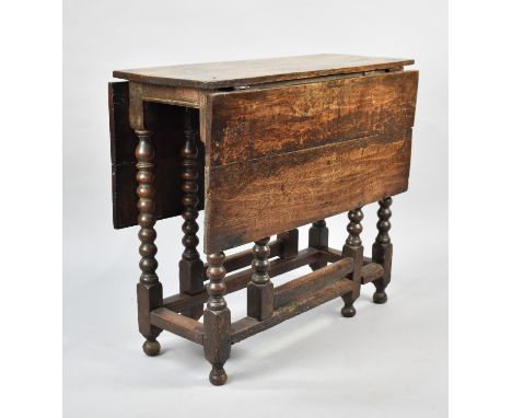 A 19th Century Oak Narrow Drop Leaf Table with Bobbin Gate Leg Base, 84cms Wide