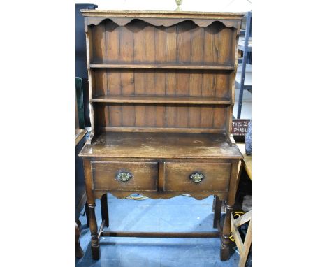An Edwardian Oak Two Drawer Dresser with Raised Shelf Plate Rack, 107cms Wide