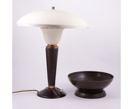 An Art Deco Bakelite table lamp, shallow domed shade in cream finish, raised on a shaped tapering column with flared foot, 47