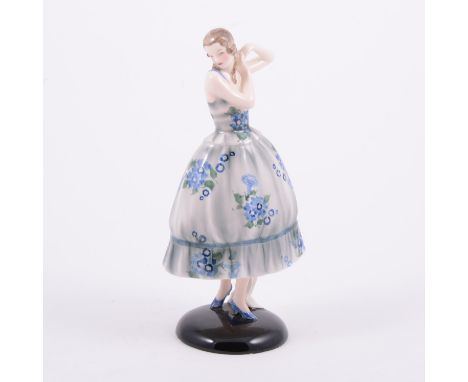 Goldscheider, an Art Deco ceramic figure of a lady, wearing a blue floral dress, factory back stamps, numbered 6491-54-11, 19