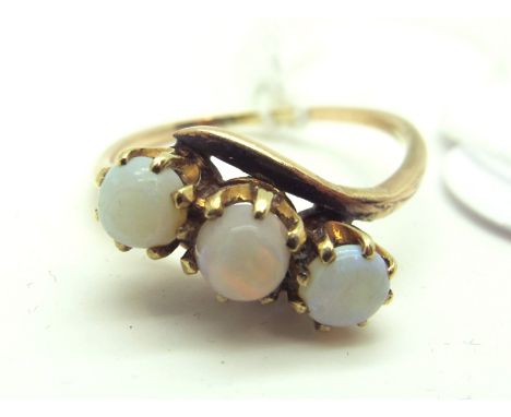 A Three Stone Opal Ring, the uniform circular cabochon claw set, of crossover design.