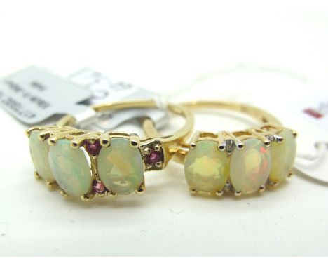 The Genuine Gemstone Company; A Modern 9ct Gold Oval Three Stone Ring, with inset highlights, between plain shoulders,*Certif