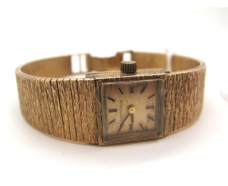 Longines; A Vintage 9ct Gold Cased Ladies Wristwatch, the signed textured dial with line markers, the movement stamped "Longi