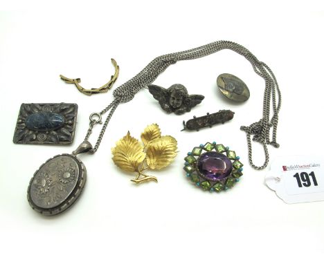 A Large Amethyst Single Stone Brooch, oval collet set within shaped collet set border, of suffragette style; A Modern Leaf Br