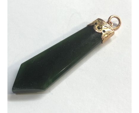 Vintage gold mounted jade pendant measures approx 45mm by 14mm  good condition 