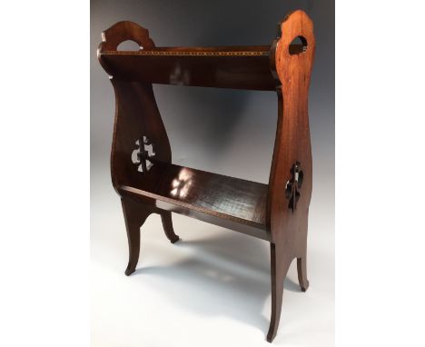 An Edwardian mahogany two-tier floor standing book trough, shaped and pierced end supports, marquetry banded borders, 69cm hi