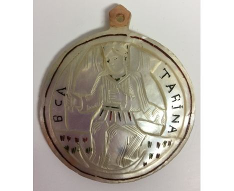 A South European mother of pearl pilgrim's pendant, carved with the Virgin Mary and inscribed B CA TARINA, 6.5cm diam