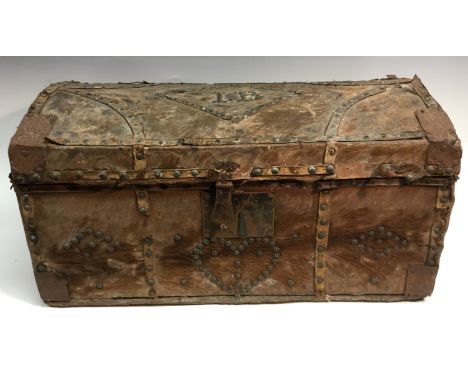 A George III pony skin domed rectangular trunk, hinged cover, outlined throughout with brass studwork and initialled IB above