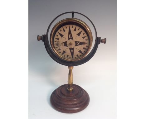 A late Victorian gentleman's desk-top gimbal compass, 7.7cm card register, the pivoting frame supported by a brass column, sp