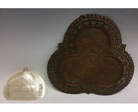 An Indo-Portuguese pearl shell hand stoop, carved with the Last Supper, the sides with pierced tracery, 15cm wide, possibly G
