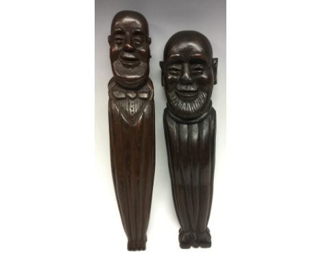 A late 19th century novelty oak figural pilaster, carved with a bald gentleman wearing a bow tie, 40cm high; another, similar