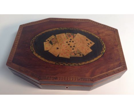 A George III fruitwood and patridge wood lozenge shaped playing card box, hinged cover decorated within an oval reserve with 