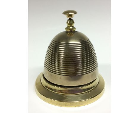 A late Victorian/Edwardian brass counter bell, push button, reeded dome, skirted base, 12.5cm high, c.1900