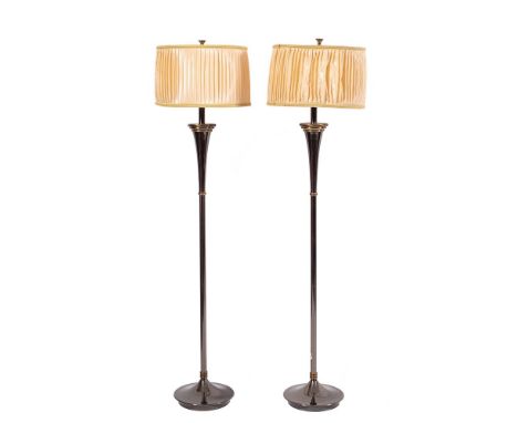 A pair of brushed metal standard lamps, modern; with pleated cylindrical shades around electrical fitments, on knopped shafts