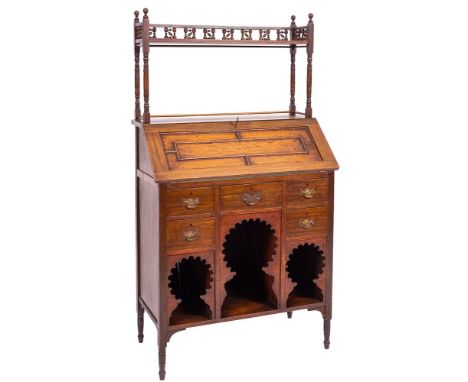 An oak 'Medina' bureau in Arts and Crafts style, designed by Leonard F. Wyburd for Liberty and Co, early 20th century; in Moo