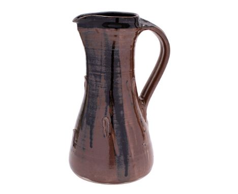 *Jeremy Leach [b. 1941] a large stoneware pitcher of tapering form with ribbed strap handle the body applied with raised stud