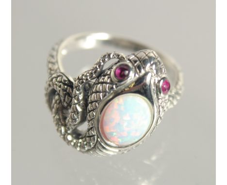 A SILVER OPAL AND RUBY SNAKE RING.