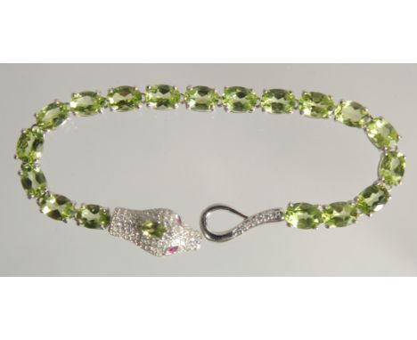 A SILVER PERIDOT SET SNAKE BANGLE.