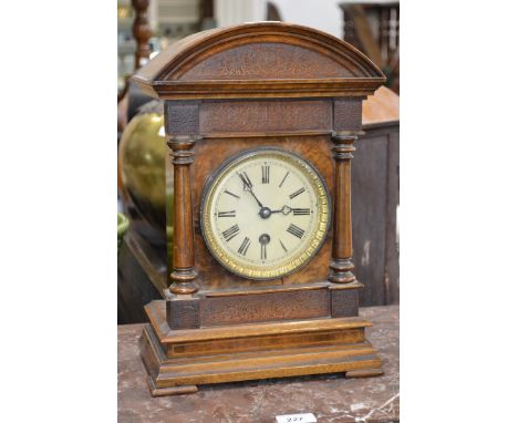 A walnut veneer mantle clock, 30 hour, Roman numerals, stepped plinth base