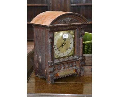 A late 19th Century German mahogany mantle clock, twin winding holes, Roman numerals, chiming on a bell, presentation plaque 