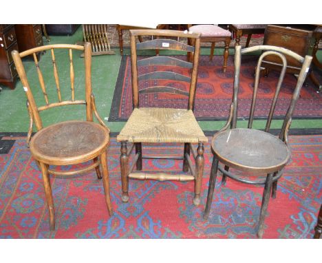 An early 20th century bentwood hall chair; another bentwood chair; a ladder back rush seated chair (3)