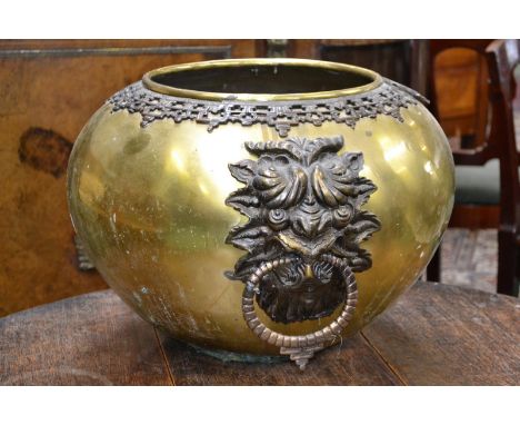 A large brass oriental style floor planter with dragon drop handles.