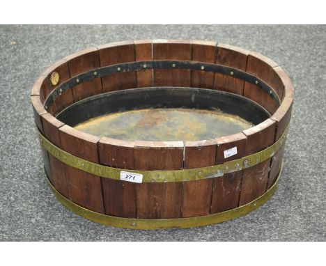 A Lister and Co. oak and brass barrel planter