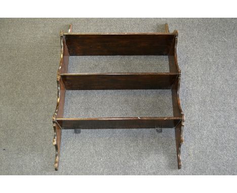 A stained pine three shelf wall rack
