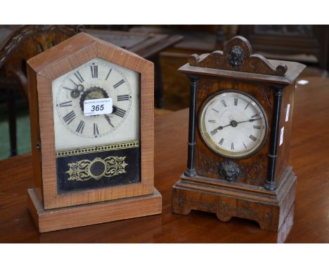 A German walnut mantle clock, white dial, Roman numerals, lion mask motif, late 19th Century, an American mantle alarm clock 