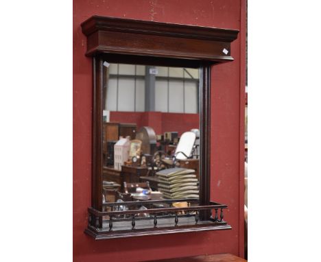 A mahogany wall mirror with galleried shelf