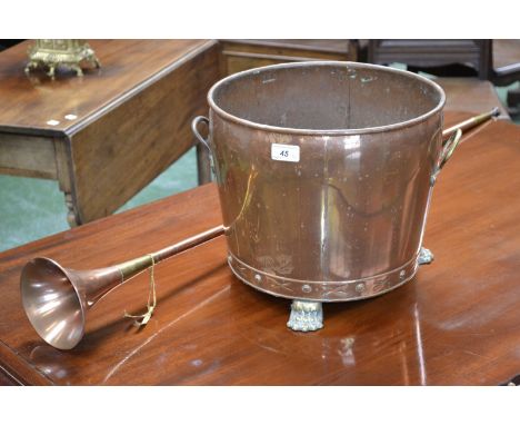 A copper and brass coal scuttle, claw feet; a hunting horn (2)