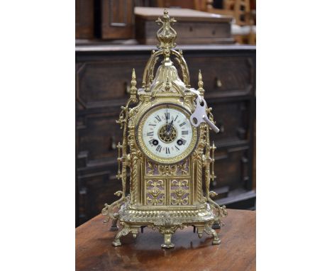 A gilt brass lantern style mantel clock of architectural form, twin winding holes, Roman numerals, striking on a bell, key 37