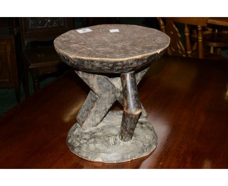 Tribal Art - an Ashanti headrest or stool, dished circular top, inclining angular column, domed base, 26.5cm high, 28cm diam 