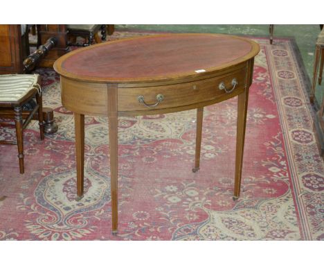 An Edwardian ladies oval writing desk, inset leather writing surface, boxwood and ebony stringing throughout, tapering square