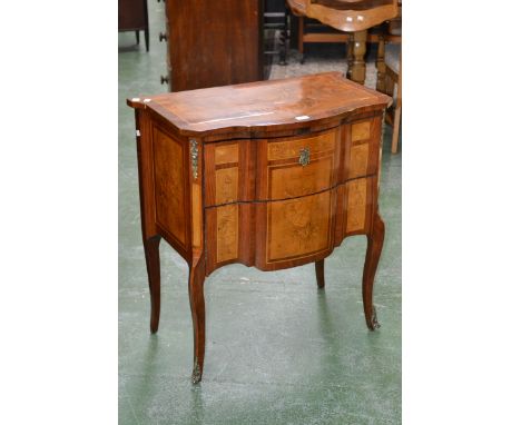 A French style marquetry two drawer commode, serpentine top inlaid with satinwood flora, cabriole forelegs, gilt metal mounts