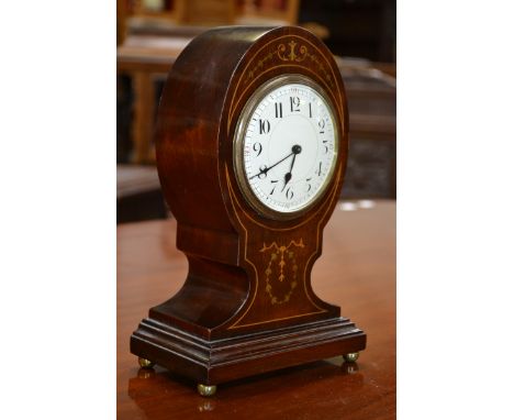An Edwardian inlaid mahogany balloon shaped mantle clock, Arabic numerals, brass bun feet