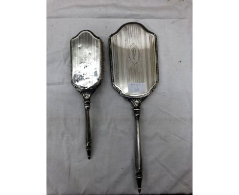 A sterling silver American hand mirror and brush: maker's mark monogram 'CW' with an arrow, c1940s