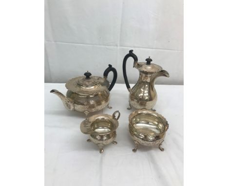 A HM silver tea, water, sucrier &amp; creamer set with planished body &amp; card cut rims on trefoil feet by C Boughton &amp;