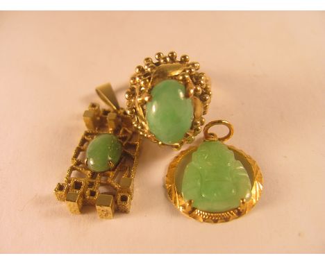 A 14ct yellow gold jade set ring, together with two gold pendants, also set with jade