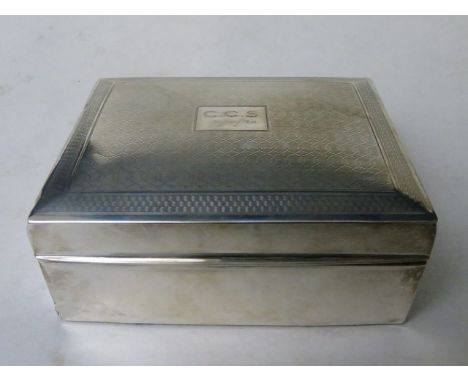 A 1920s silver cigarette box having an engine turned lid